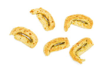 Group of five halves of crispy savory cheese palmier flatlay isolated on white background