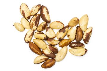 Lot of whole unshelled brazil nut folded like heart flatlay isolated on white background