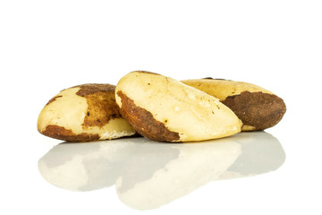 Group of three whole fresh unshelled brazil nut isolated on white background