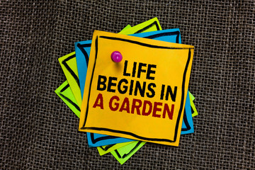 Text sign showing Life Begins In A Garden. Conceptual photo Agriculture Plants growing loving for gardening Black bordered different color sticky note stick together with pin on jute sack