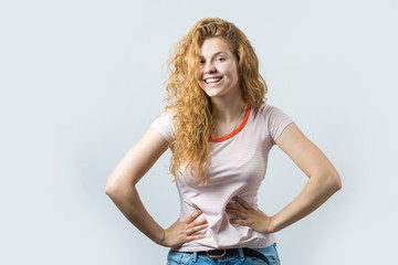Portrait of an enthusiastic young girl screaming with joy over white background