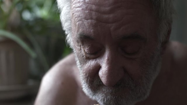 Beggar eating piece of bread