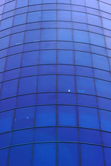 Fototapeta na wymiar Glass blue square Windows of facade modern city business building skyscraper. Modern apartment buildings in new neighborhood. Windows of a building, texture. 