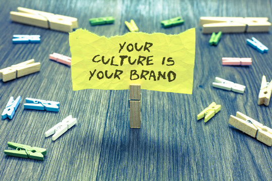 Handwriting text Your Culture Is Your Brand. Concept meaning Knowledge Experiences are a presentation card Paperclip hold written torn page many clips laid on bluish wooden floor