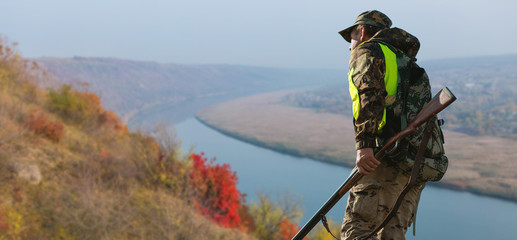 Hunter with a german drathaar and spaniel, pigeon hunting with dogs against the backdrop of a...