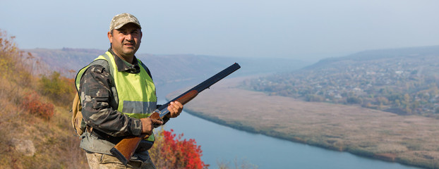 Hunter with a german drathaar and spaniel, pigeon hunting with dogs against the backdrop of a...