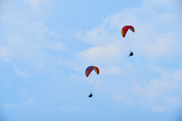 Paraglider flying over the Garda Lake (Lago di Garda or Lago Benaco). Paragliding on Monte Baldo. Panorama of the gorgeous Garda lake surrounded by mountains, Malcesine, Italy