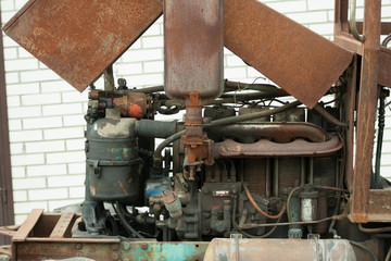 Engine on old rusty tractor. Non-painted metal