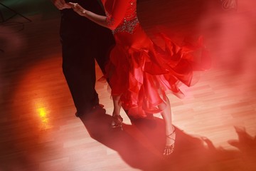 Man and woman dancing Salsa on dark