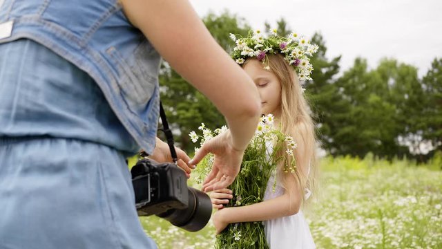Girl Flowers Bunch Photograph Floral Wreath Pose. Pretty Caucasian Blonde Child Blossom Meadow Summer Field. Cute Female Kid Enjoy Nature Hold Wildflowers Bouquet Free Time Leisure Concept