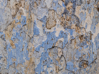 Numerous layers of old paint on limestone stone.