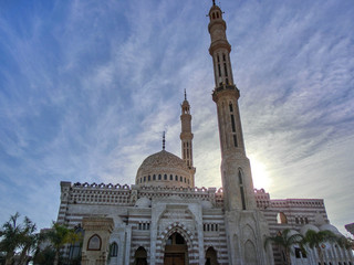 Fototapeta na wymiar beautiful mosque with minaret lit by sunset, dahab, egypt