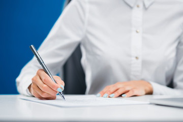 Fototapeta premium Businesswoman writing down on a sheet of paper innovative ideas.