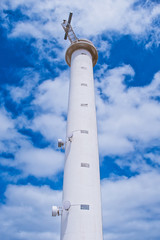 lighthouse near Playa Blanca in Lanzarote called Faro de Punta Pechiguera against blue cloudy sky