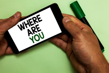 Writing note showing Where Are You. Business photo showcasing Give us your location address direction point of reference Human hand hold phone with texts touched green marker