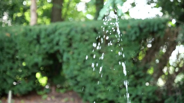 Slow motion stream of water in arch 
