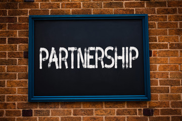 Obraz premium Conceptual hand writing showing Partnership. Business photo showcasing Association of two or more people as partners Cooperation Unity Framed hang black board study class brick wall background