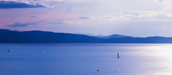 Recreational boating on Lake Champlain in Burlington, Vermont, USA at dusk.