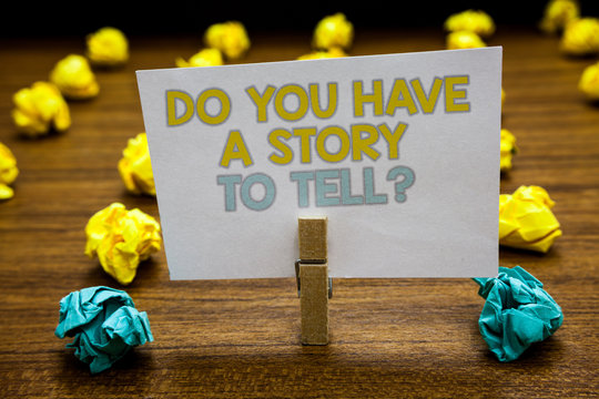 Writing note showing Do You Have A Story To Tell question. Business photo showcasing Storytelling Memories Tales Experiences Written notepad stand with paperclip yellow blue lobs on wooden deck