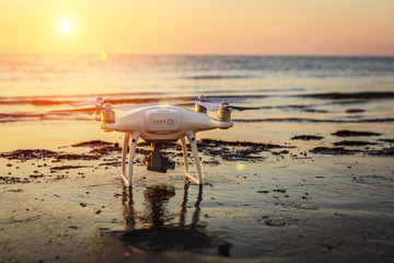 flying drone on a background of sea sunset