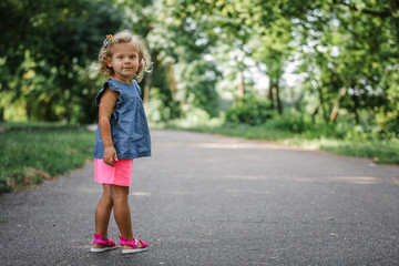 Fototapeta premium little girl walks in the park