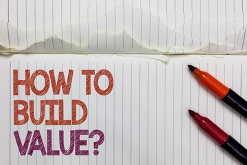 Obraz premium Text sign showing How To Build Value question. Conceptual photo Ways for developing growing building a business White torn page written some letters beside laid two red marker