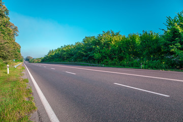 Fototapeta premium Asphalt highways and mountains under the blue sky