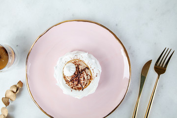 top view on healthy vegan dessert anna pavlova on white marble table with coffee and food tableware. Copy space for design. Fresh vegan raw dessert. Healthy food. meringue sweet cake