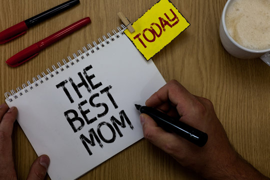 Handwriting text writing The Best Mom. Concept meaning Appreciation for your mother love feelings compliment Man holding marker notebook clothespin reminder wooden table cup coffee