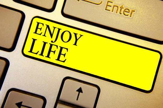 Handwriting text Enjoy Life. Concept meaning Any thing, place,food or person, that makes you relax and happy Keyboard yellow key Intention create computer computing reflection document