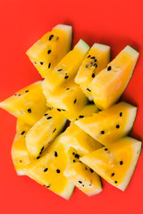 cut off triangular slices of ripe yellow watermelon on white background