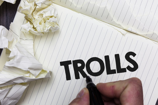 Conceptual hand writing showing Trolls. Business photo showcasing Online troublemakers posting provocative inflammatory messages Paper object notepad crumpled papers ideas several tries