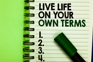 Handwriting text Live Life On Your Own Terms. Concept meaning Give yourself guidelines for a good living Written letters and numbers on notepad laid green marker green back