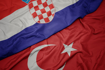 waving colorful flag of turkey and national flag of croatia.