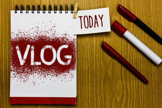 Text sign showing Vlog. Conceptual photo Entertaining multimedia self broadcasting news reporting stories Reminder appointment daily note paper work book job list marker pens clip