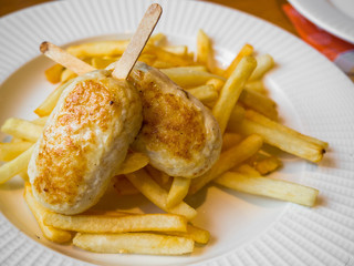 child menu - french fries and chicken cutlets in the form of popsicle