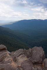 Fototapeta premium A cliff in the foreground with forests in the background at the Wentworth Falls in the Blue Mountains in Australia