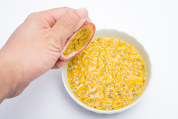 hand holding half cut passion fruit isolated on white background, sour fruit, fruit background, healthy food