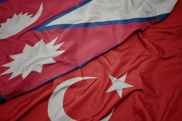 waving colorful flag of turkey and national flag of nepal.