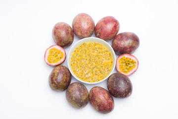 Half cut passion fruit and passion fruit juice in a bowl isolated on white background, sour fruit, fruit background, healthy food