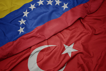 waving colorful flag of turkey and national flag of venezuela.