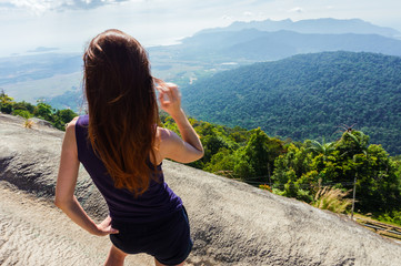 Young traveler girl stand on the top of mountain
