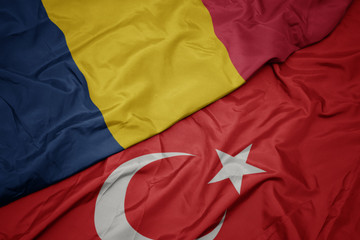 waving colorful flag of turkey and national flag of chad.