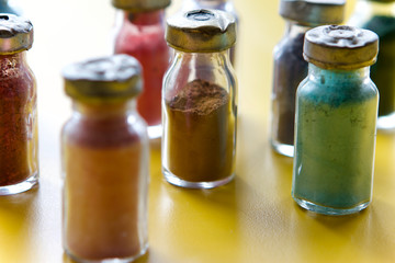 Colour pigment in small glass bottles, back lit