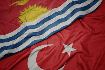 waving colorful flag of turkey and national flag of Kiribati .