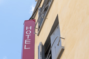 red and white letters sign hotel in building street in France south