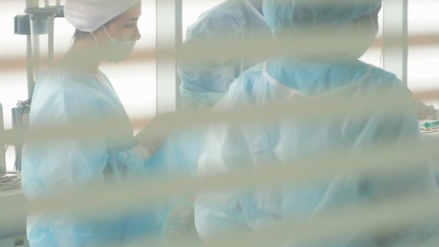 Team of doctors repair and diagnose internal problems.