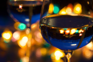 wine glasses with party lights in the background