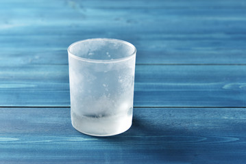 Frost-covered glass on a wooden table