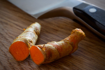 Fresh Turmeric on wooden chopping board